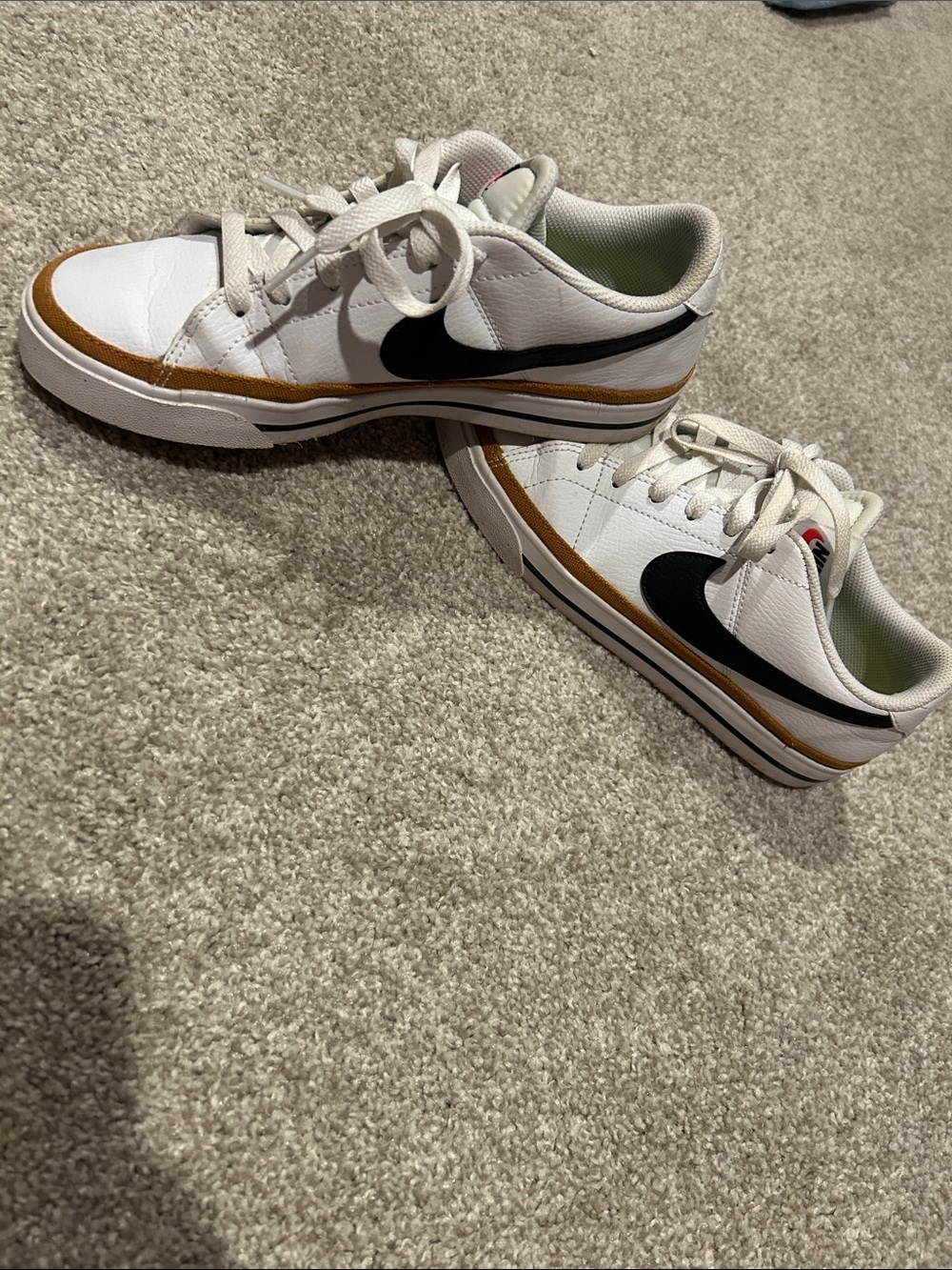 Nike White Sneakers with Black Swoosh and Gold Trim